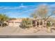 Charming single-story home featuring a three-car garage, desert landscaping, and a welcoming entrance at 18932 N Aztec Point Dr, Surprise, AZ 85387