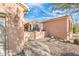 Home exterior featuring an address number, decorative gate, and desert-style landscaping at 18932 N Aztec Point Dr, Surprise, AZ 85387