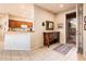 Neutral colored foyer with tile flooring, and security door leading outside, with kitchen adjacent at 18932 N Aztec Point Dr, Surprise, AZ 85387