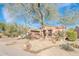 Charming home featuring desert landscaping, mature tree, and a well-maintained front yard at 18932 N Aztec Point Dr, Surprise, AZ 85387