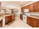 Open kitchen with granite countertops, wooden cabinets and plenty of natural light at 18932 N Aztec Point Dr, Surprise, AZ 85387