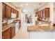 Bright kitchen with granite counters and wood cabinets, flowing into dining area at 18932 N Aztec Point Dr, Surprise, AZ 85387