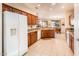 Bright kitchen with granite countertops, wooden cabinets, and modern appliances at 18932 N Aztec Point Dr, Surprise, AZ 85387