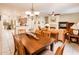Open-concept living space with dining area, fireplace, and view of the modern kitchen at 18932 N Aztec Point Dr, Surprise, AZ 85387