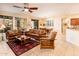 Bright and spacious living room with tile flooring, comfortable seating, and open to the dining area and kitchen at 18932 N Aztec Point Dr, Surprise, AZ 85387