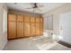 Spacious storage room with ample wood cabinets and ceiling fan at 18932 N Aztec Point Dr, Surprise, AZ 85387