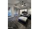 Bright living room with wood-look tile flooring, modern ceiling fan, and updated kitchen view at 200 E Southern Ave # 242, Tempe, AZ 85282