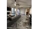 Open living room featuring wood-look tile flooring, a fireplace, and access to the balcony at 200 E Southern Ave # 242, Tempe, AZ 85282