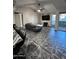 Bright living room featuring wood-look tile flooring, fireplace, and exterior balcony at 200 E Southern Ave # 242, Tempe, AZ 85282