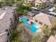 An aerial view highlights the community pool area with ample seating, lush landscaping, and nearby residences at 20100 N 78Th Pl # 1062, Scottsdale, AZ 85255