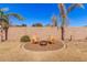 Landscaped backyard with fire pit and seating at 20562 E Raven Dr, Queen Creek, AZ 85142