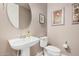 Clean bathroom with pedestal sink and toilet at 20562 E Raven Dr, Queen Creek, AZ 85142
