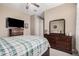 Spacious bedroom with a full-size bed and dresser at 20562 E Raven Dr, Queen Creek, AZ 85142