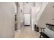 Bright entryway with tiled floors, staircase, and a bench with pillows at 20562 E Raven Dr, Queen Creek, AZ 85142