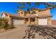 Two-story house with a three-car garage and brick paved driveway at 20562 E Raven Dr, Queen Creek, AZ 85142