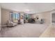 Living area featuring gray carpet, large windows, and a piano at 20562 E Raven Dr, Queen Creek, AZ 85142