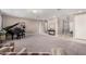 Spacious living room with gray carpet, piano, and comfortable seating at 20562 E Raven Dr, Queen Creek, AZ 85142