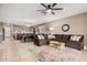 Open concept living room and kitchen with sectional sofa and large windows at 20562 E Raven Dr, Queen Creek, AZ 85142