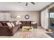 Spacious living room with sectional sofa, access to backyard, and large windows at 20562 E Raven Dr, Queen Creek, AZ 85142