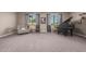 Relaxing living room with gray carpet, comfy chair, and a grand piano at 20562 E Raven Dr, Queen Creek, AZ 85142