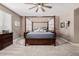 Bright main bedroom with a king-size bed and a ceiling fan at 20562 E Raven Dr, Queen Creek, AZ 85142