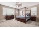 Spacious main bedroom with a four-poster bed and plenty of light at 20562 E Raven Dr, Queen Creek, AZ 85142