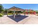 Community playground pavilion with picnic tables and bbq grill near the playground and lush greenery at 20562 E Raven Dr, Queen Creek, AZ 85142