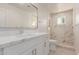 Clean bathroom, featuring a white vanity and marble shower at 2129 S Los Feliz Dr, Tempe, AZ 85282