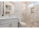 Modern bathroom with white vanity, marble shower, and toilet at 2129 S Los Feliz Dr, Tempe, AZ 85282
