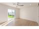 Bright bedroom featuring light wood floors and sliding glass doors to backyard at 2129 S Los Feliz Dr, Tempe, AZ 85282