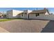 Modern home exterior showcasing a clean, white facade, artificial turf, and a paver driveway at 2129 S Los Feliz Dr, Tempe, AZ 85282