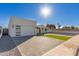 Modern home exterior with a clean, white facade, artificial turf, and a paver driveway at 2129 S Los Feliz Dr, Tempe, AZ 85282