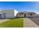 Modern single-story home with a two-car garage and landscaped lawn at 2129 S Los Feliz Dr, Tempe, AZ 85282