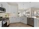 Spacious kitchen with white cabinets, stainless steel appliances, and corner sink at 2166 W Peninsula Cir, Chandler, AZ 85248