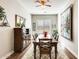 Well-lit dining room features a wood table and chairs, decorative tapestry, and hardwood floors at 2238 E Saddlebrook Rd, Gilbert, AZ 85298