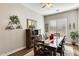Elegant dining room with dark wood table and chairs, decorative wall accents, and hardwood floors at 2238 E Saddlebrook Rd, Gilbert, AZ 85298