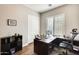 Bright home office with L-shaped desk and large window at 2238 E Saddlebrook Rd, Gilbert, AZ 85298