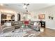 Spacious living room featuring a large sectional sofa and hardwood floors at 2238 E Saddlebrook Rd, Gilbert, AZ 85298