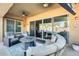 Covered patio with comfortable seating, fire pit, and sliding glass doors leading to the pool at 2238 E Saddlebrook Rd, Gilbert, AZ 85298