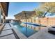 Refreshing pool with a patio, umbrella, and comfortable lounge chairs at 2238 E Saddlebrook Rd, Gilbert, AZ 85298