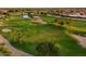 View of a lush green golf course with a pond and palm trees at 22713 N Dusty Trail Blvd, Sun City West, AZ 85375