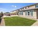 Artificial turf backyard with patio and view of the house at 27165 N 71St Ln, Peoria, AZ 85383