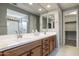 Modern bathroom with double sinks and a walk-in shower at 27165 N 71St Ln, Peoria, AZ 85383