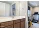 Bathroom with vanity, mirror and adjacent home gym at 27165 N 71St Ln, Peoria, AZ 85383