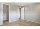 Bedroom with carpet flooring, a closet, and access to a hallway at 27165 N 71St Ln, Peoria, AZ 85383