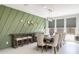 Elegant dining room with wood table and statement green wall at 27165 N 71St Ln, Peoria, AZ 85383