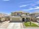 Two-story house with a landscaped yard and a two-car garage at 27165 N 71St Ln, Peoria, AZ 85383
