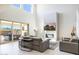 Living area with fireplace and access to backyard patio at 27165 N 71St Ln, Peoria, AZ 85383