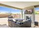 Outdoor patio with seating area, fire pit and TV at 27165 N 71St Ln, Peoria, AZ 85383