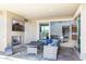 Patio with seating area, fireplace and view into home at 27165 N 71St Ln, Peoria, AZ 85383